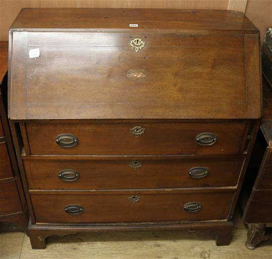 A Victorian mahogany bureau, the sloping flap with shell inlay